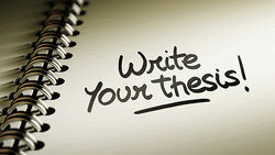 notebook with words write your thesis on the page