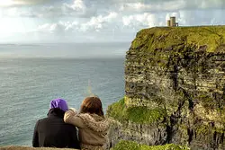 couple enjoying the view from cliff