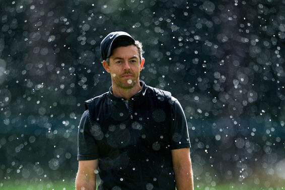 Rory McIlroy plays golf in heavy rain