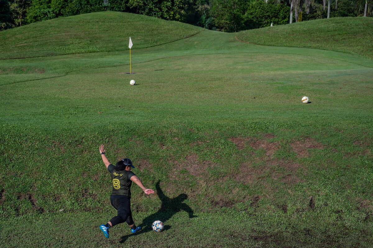 Woman playing footgolf attempting a greenside shot
