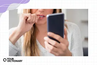 Nervous young woman using phone as Doomscrolling example