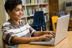 a student typing on his laptop