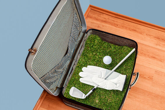 Golf suitcase packed with club, ball and glove