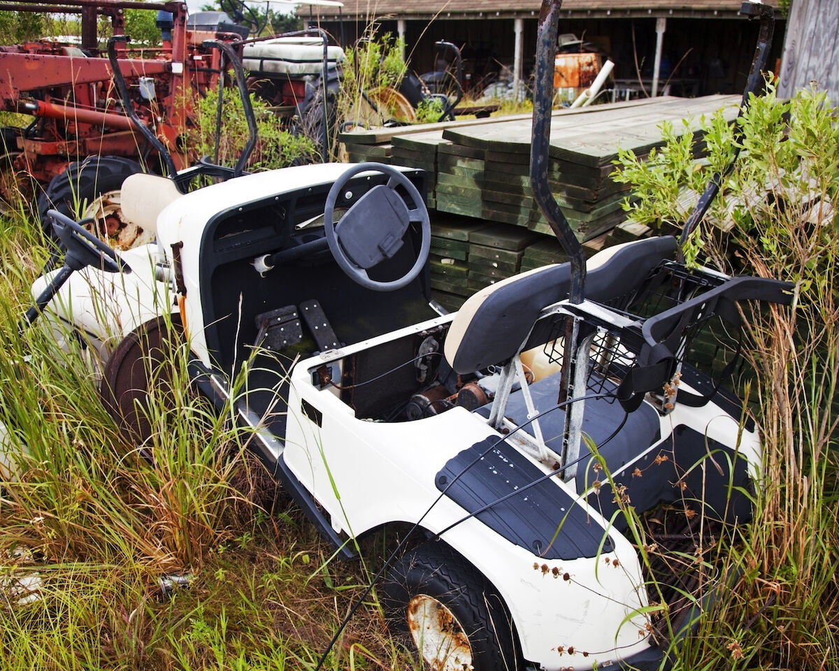 Old golf cart in junkyard