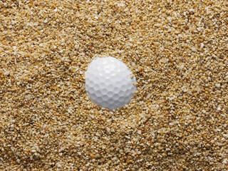Golf ball in a buried lie in the bunker