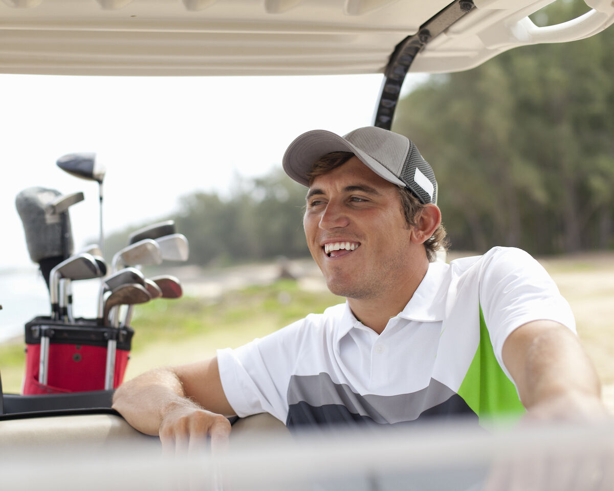 Golfer smiling in golf cart