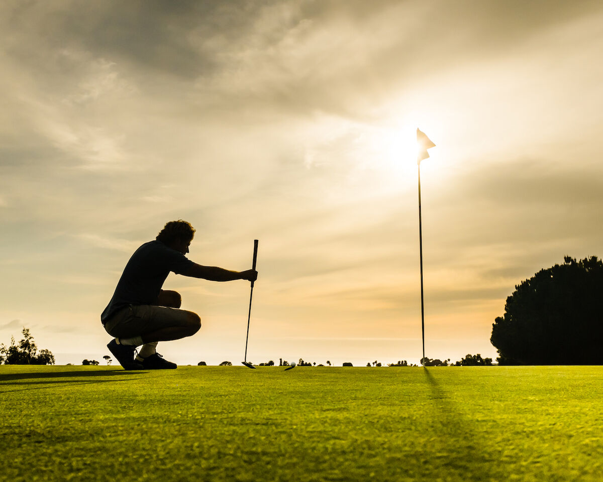 Golfer lining up his putt