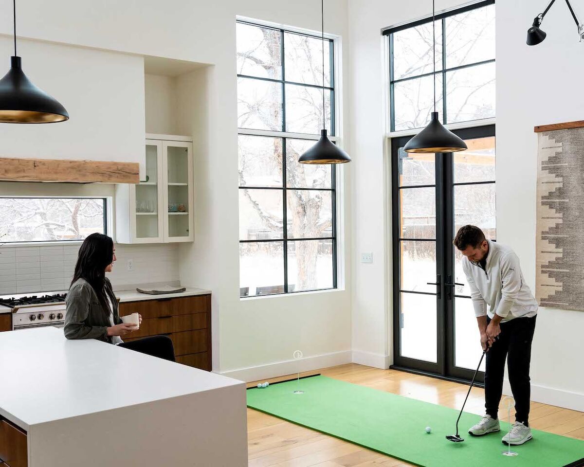 People using Birdieball putting green indoors