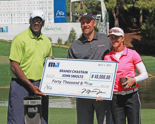 Celebrities holding check at charity tournament