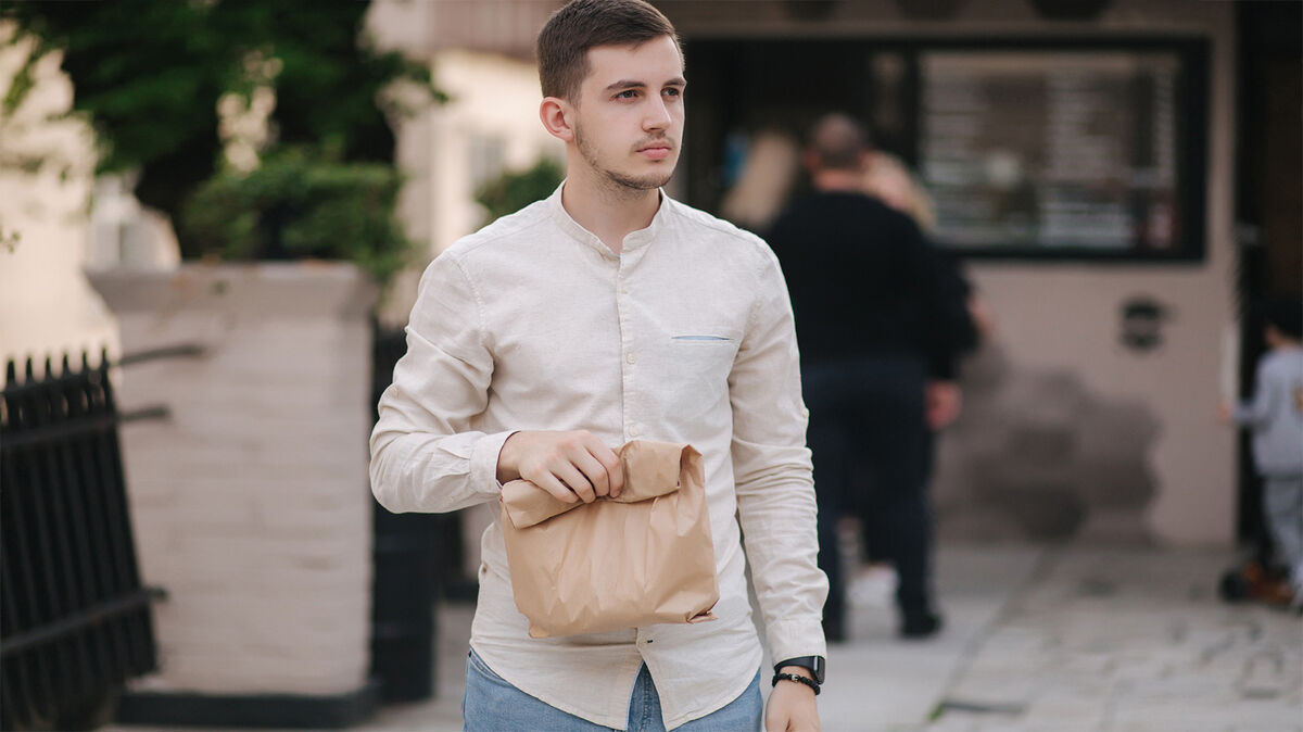 Young man with paper bag