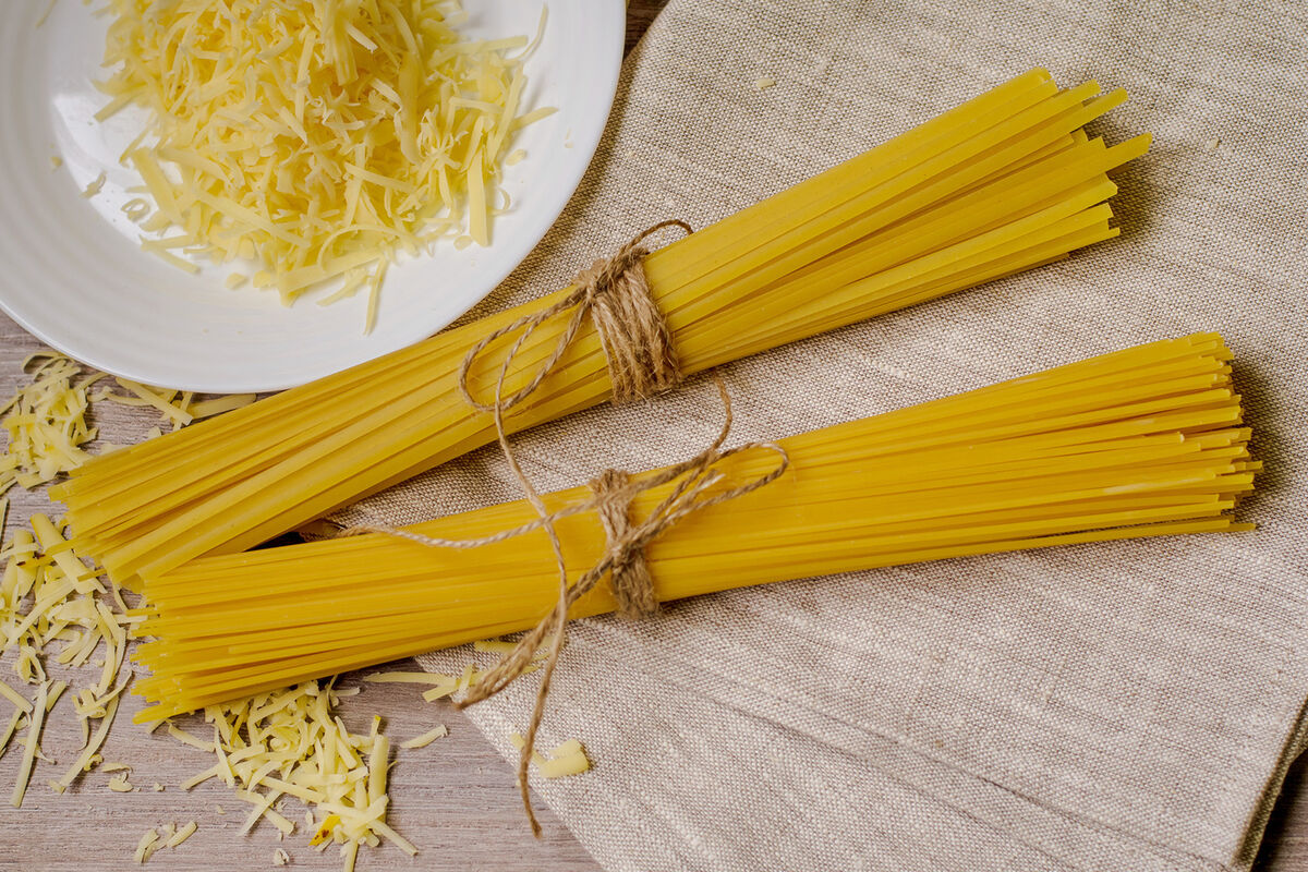 Uncooked piles of spaghetti noodles