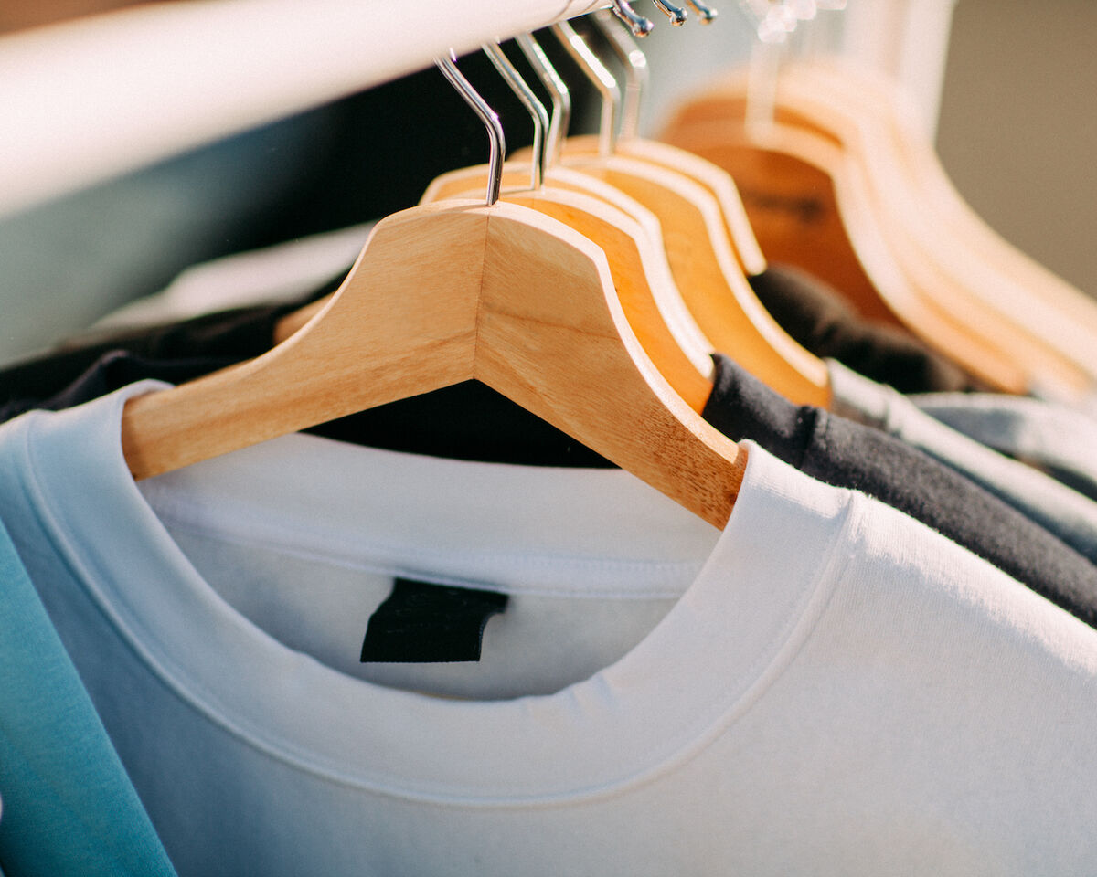 tee shirts on wooden hangers