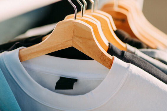 tee shirts on wooden hangers