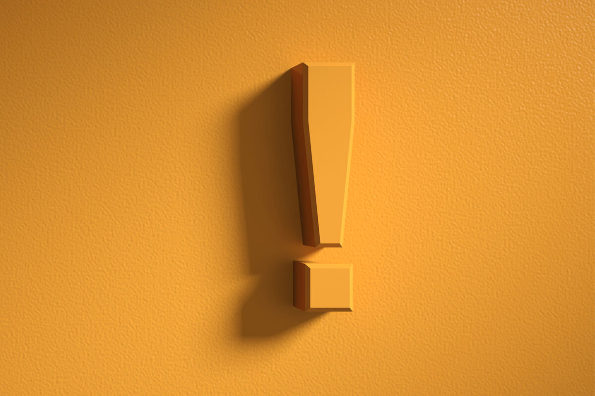 Exclamation mark on orange wall background