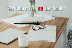 Modern workspace with journal and eyeglasses
