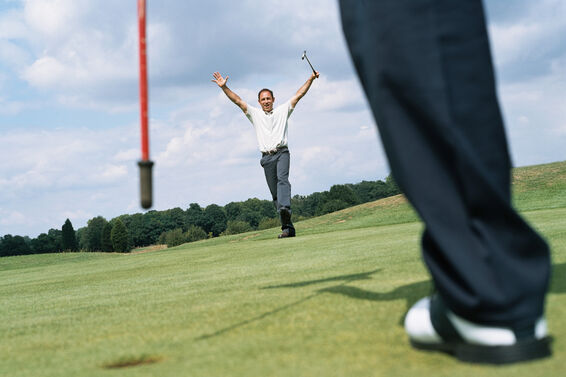 Golfer celebrates making a putt