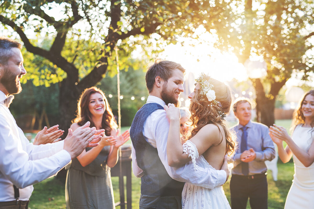 Bride and groom dancing at wedding reception outside