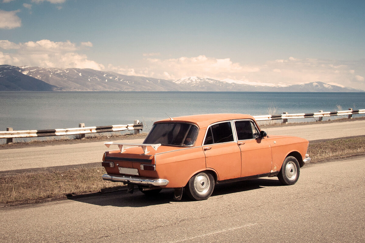 Old fashioned orange car with rear wind spoiler