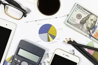 Calculator, dollar, dollar bills, pens, business charts as financial concept