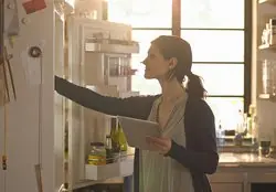 Loading a refrigerator with groceries