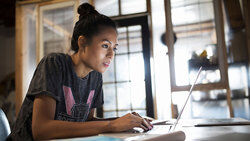 Female student researching on laptop