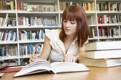 College student performing research in the library