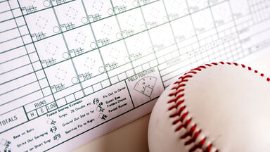 Baseball scorecard with baseball