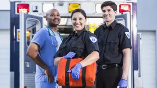 Paramedics standing in front of ambulance
