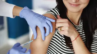 Woman receiving an injection in her arm