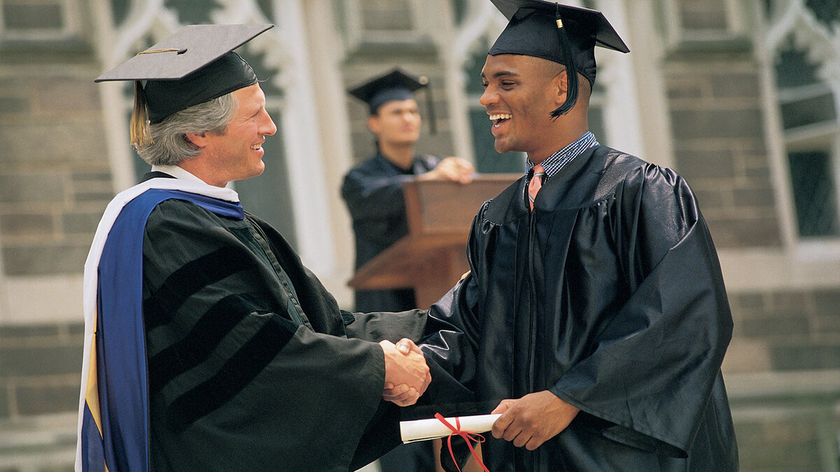 man receiving diploma at graduation