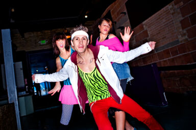 Dancers in neon clothing of the 1980s