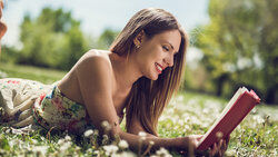 Girl reading dynamic poetry book outside