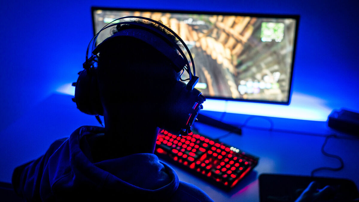 Boy playing game on computer