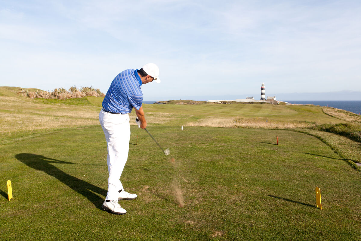 Golfer hitting a shot from the tee box