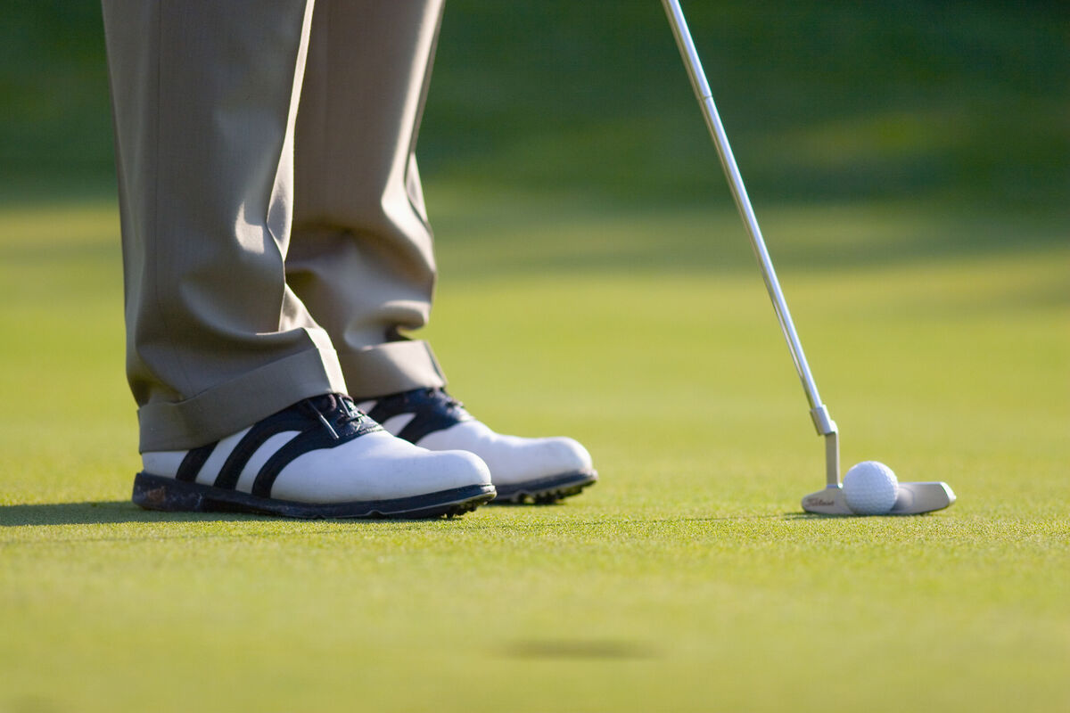 Golfer practicing a short putt