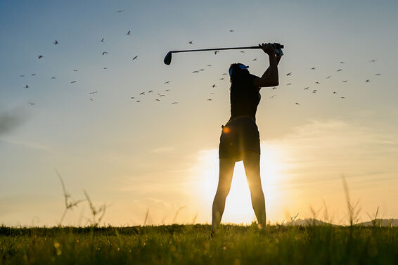 Golfer at the top of her backswing