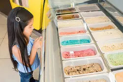 The girl always chooses the same flavor of ice cream.