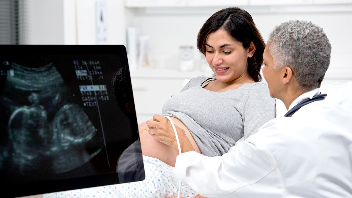 Woman doctor giving ultrasound to patient