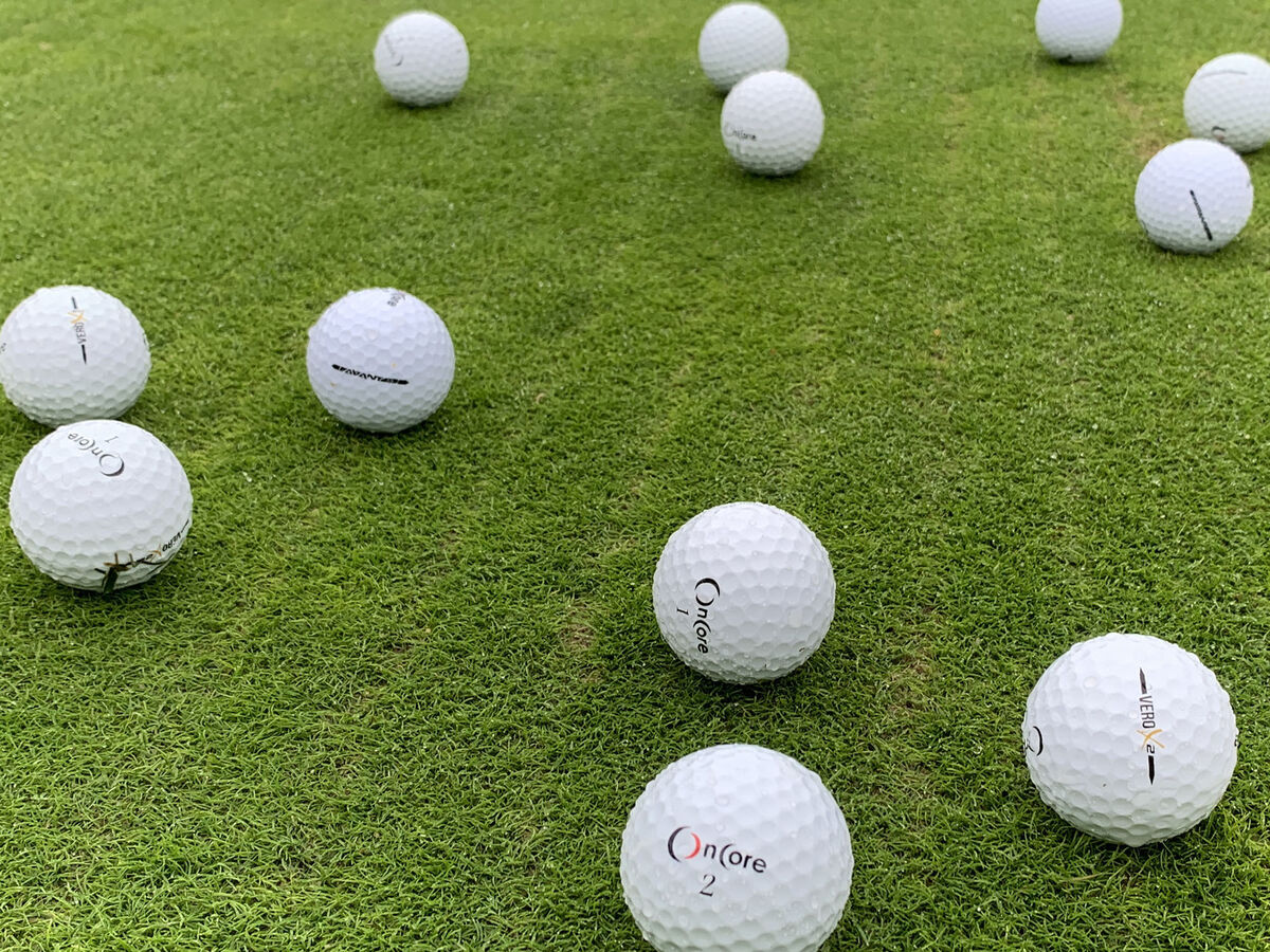 A dozen mixed OnCore golf balls on a golf course