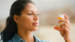 woman reading medication prescription