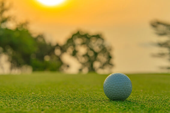 Close up of a golf ball at sunset