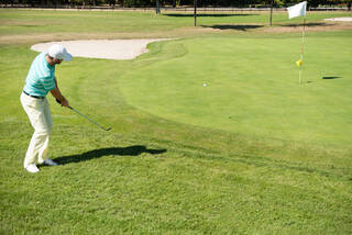 Golfer hitting a chip shot