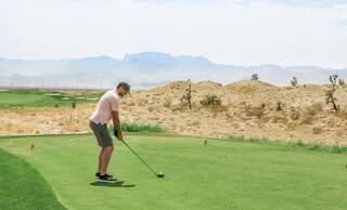 Golfer teeing off hitting a draw