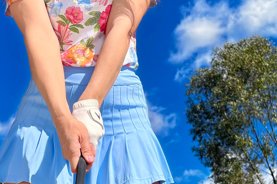 Women gripping a golf club with slightly strong golf grip