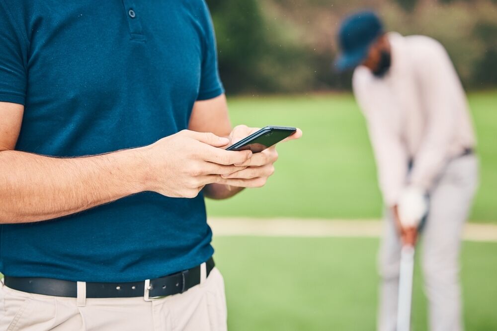 Golfer using an app during a round of golf