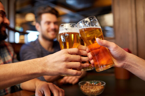 Guys raising a glass at a bachelor party
