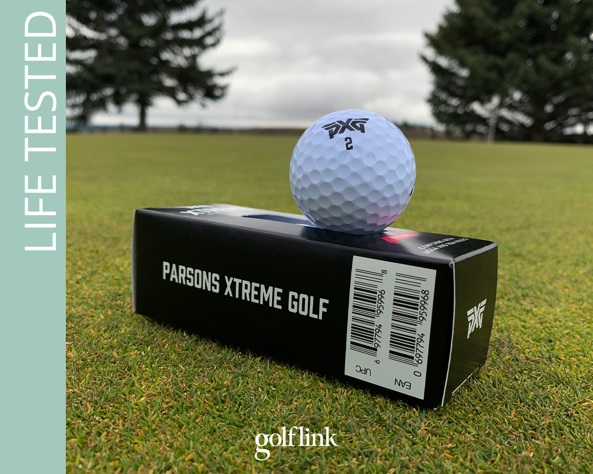 A PXG Xtreme golf ball sits on the sleeve on a putting green