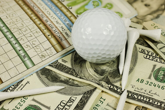 Golf accessories rest on a loose pile of cash
