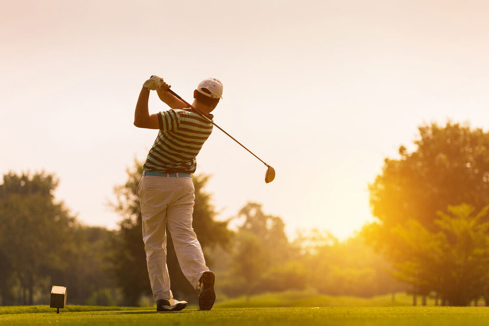 Golfer hitting a long drive off the tee