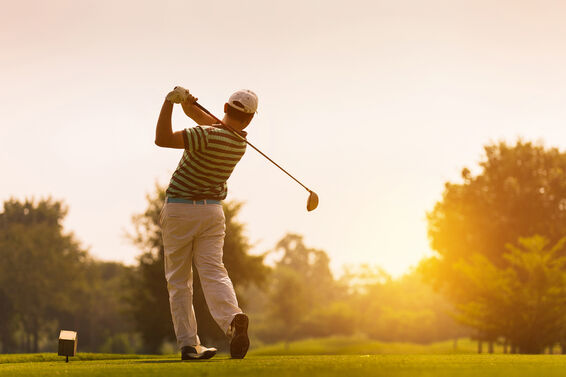 Golfer hitting a long drive off the tee